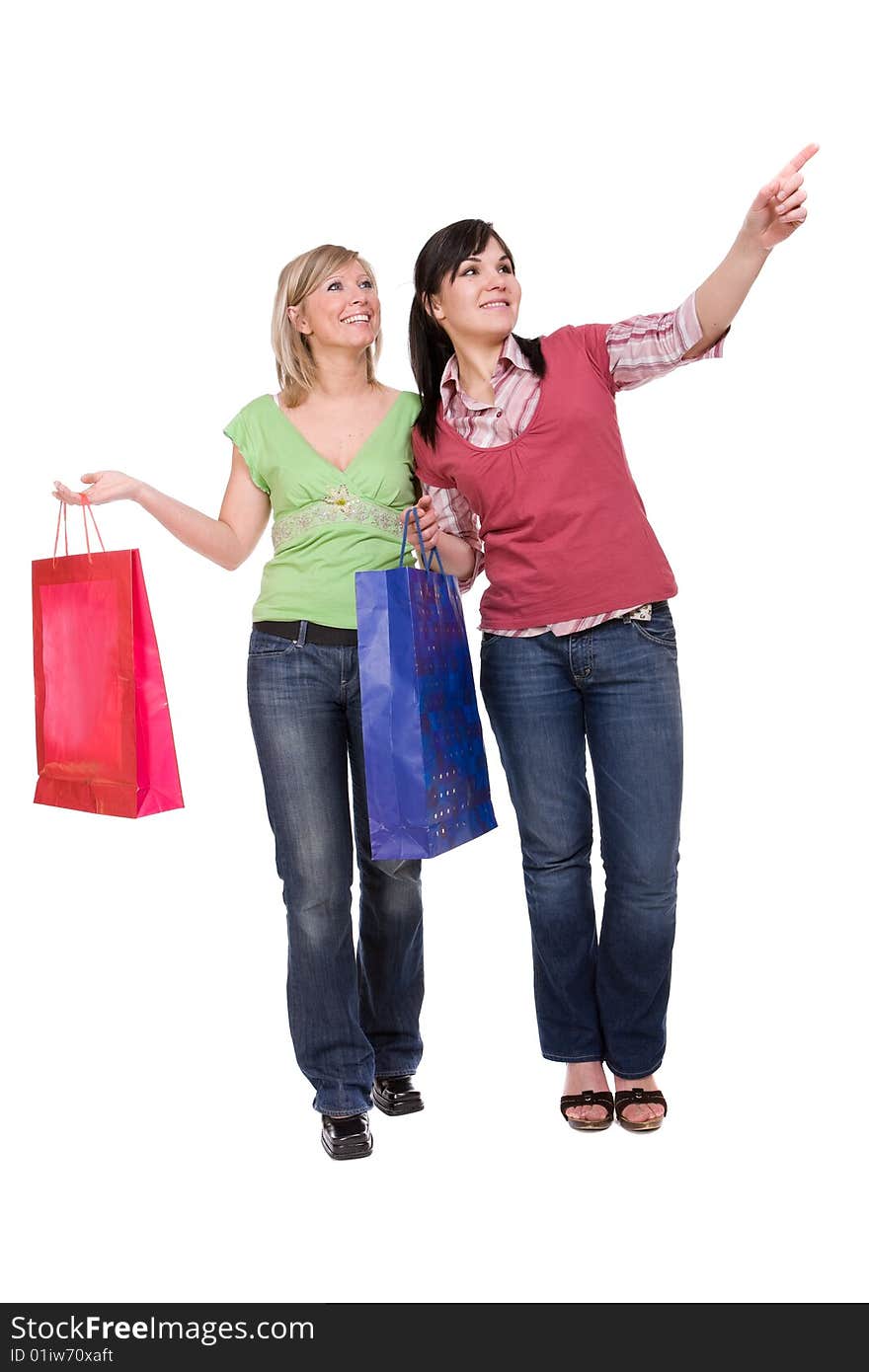 Two attractive women with shopping bags. over white background. Two attractive women with shopping bags. over white background