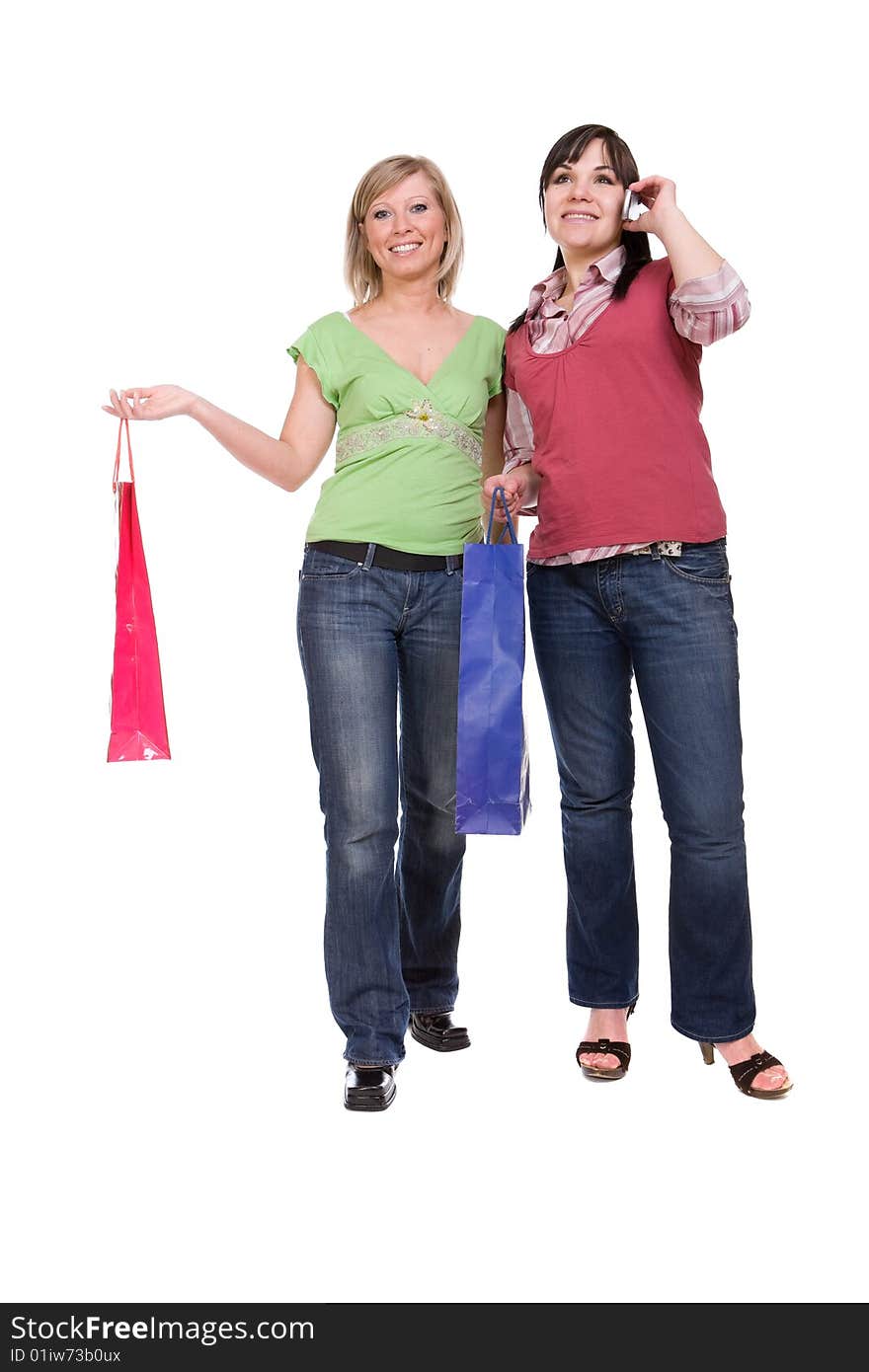 Two attractive women with shopping bags. over white background. Two attractive women with shopping bags. over white background