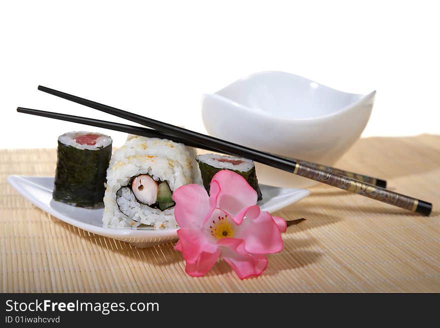 Sushi plate with chopsticks and flower