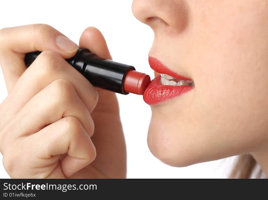 Young woman doing make-up over white