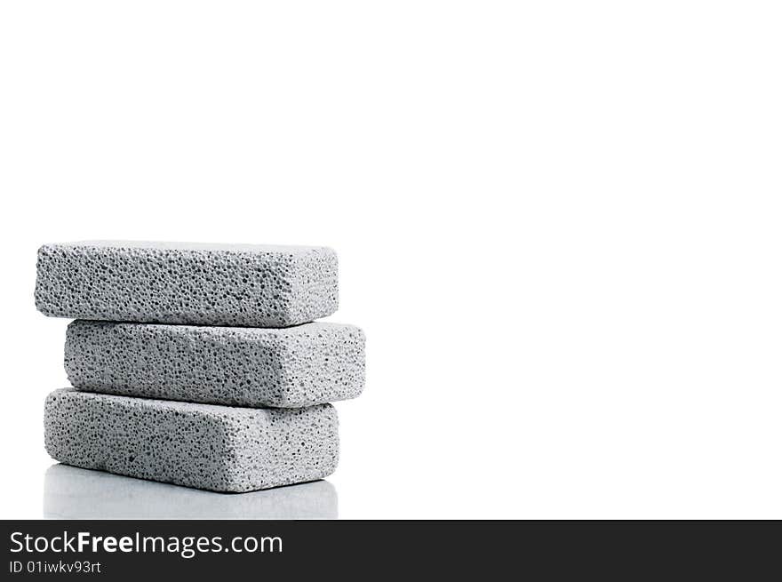 A stack of pumice stones against a white background. A stack of pumice stones against a white background.