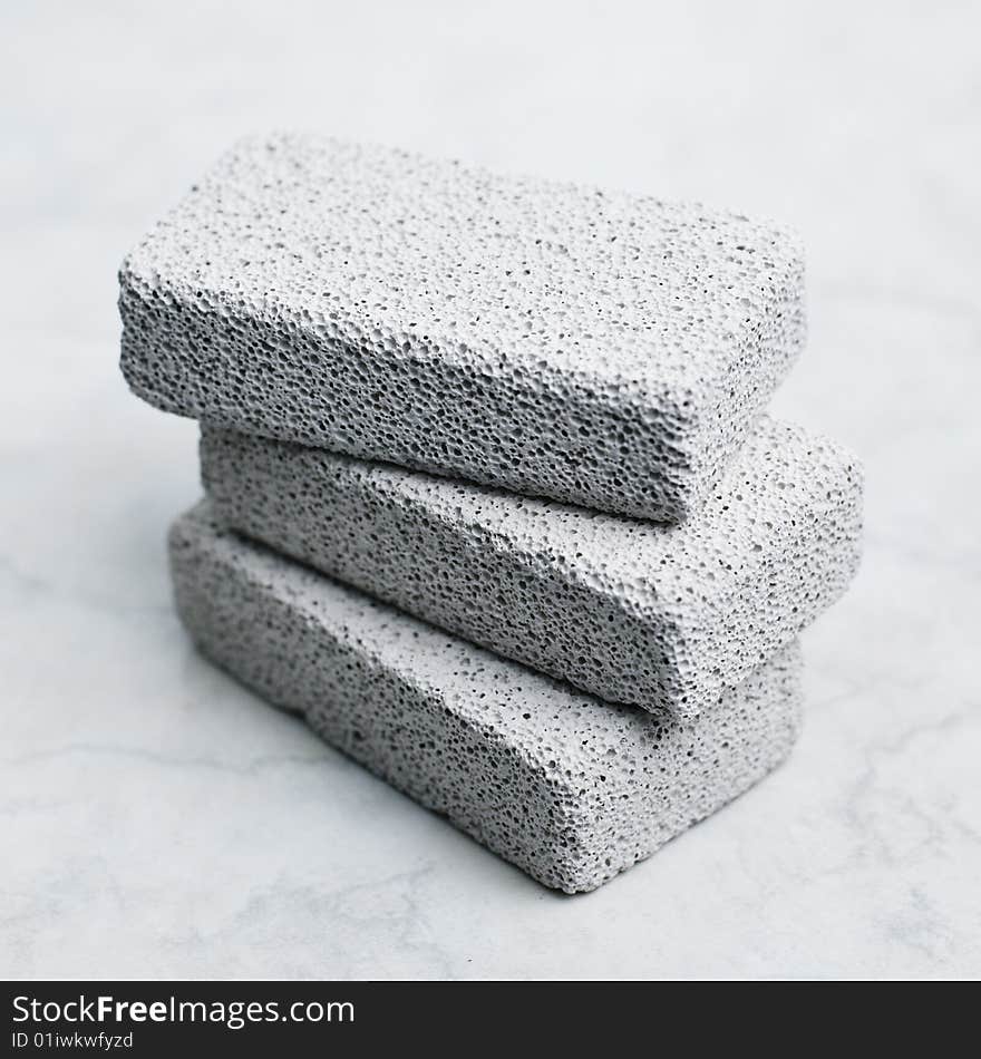 A stack of pumice stones against a white background. A stack of pumice stones against a white background.