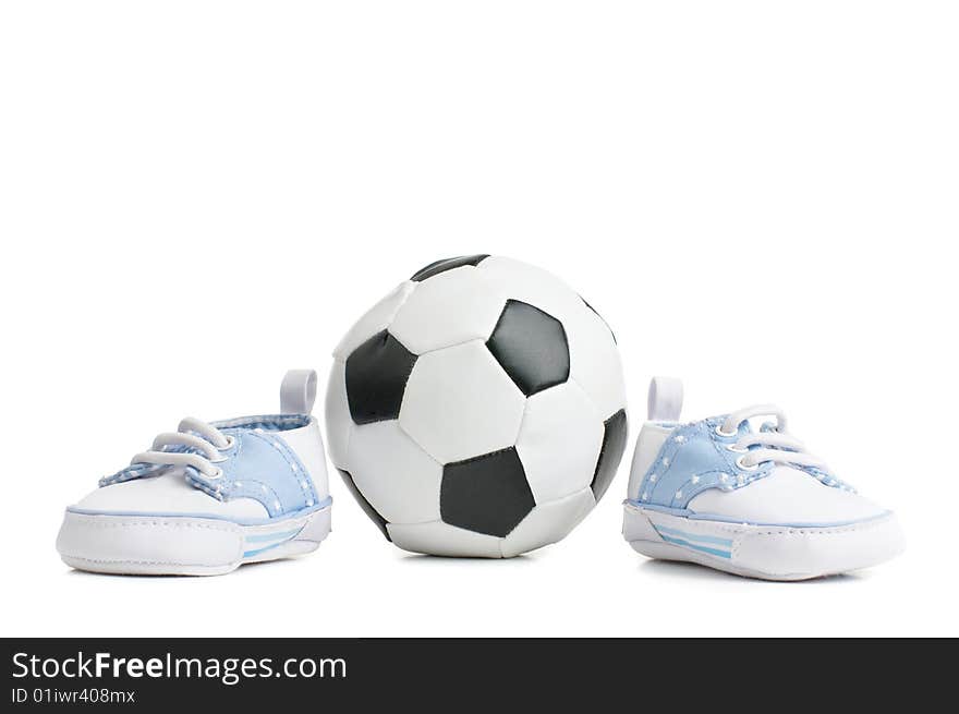 A football / soccer ball with baby shoes, on white.