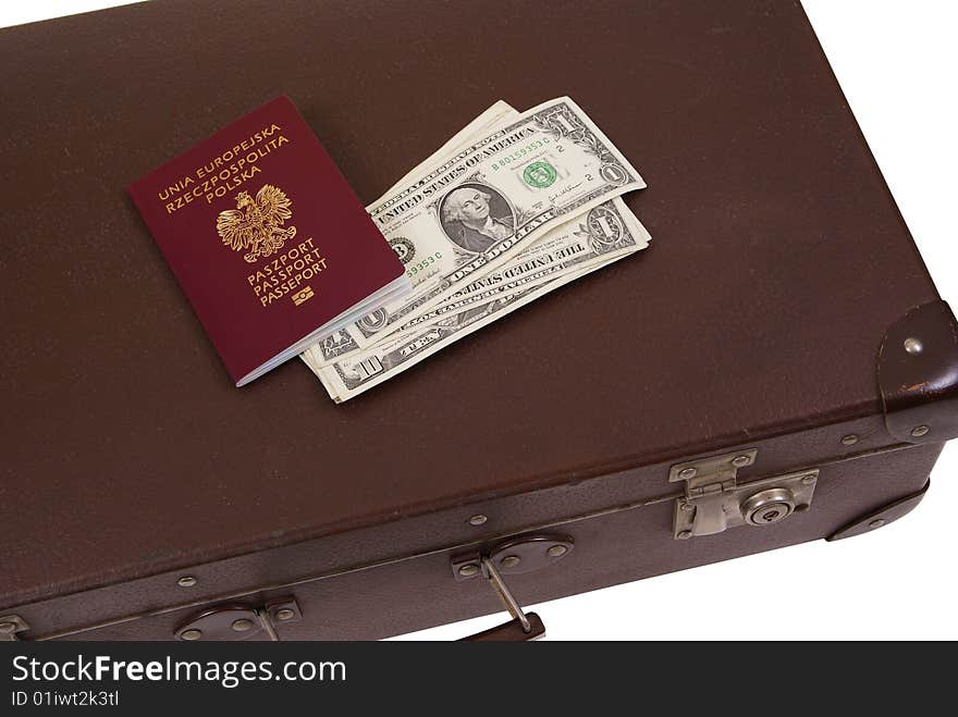 Old suitcase with money and passport isolated on white background