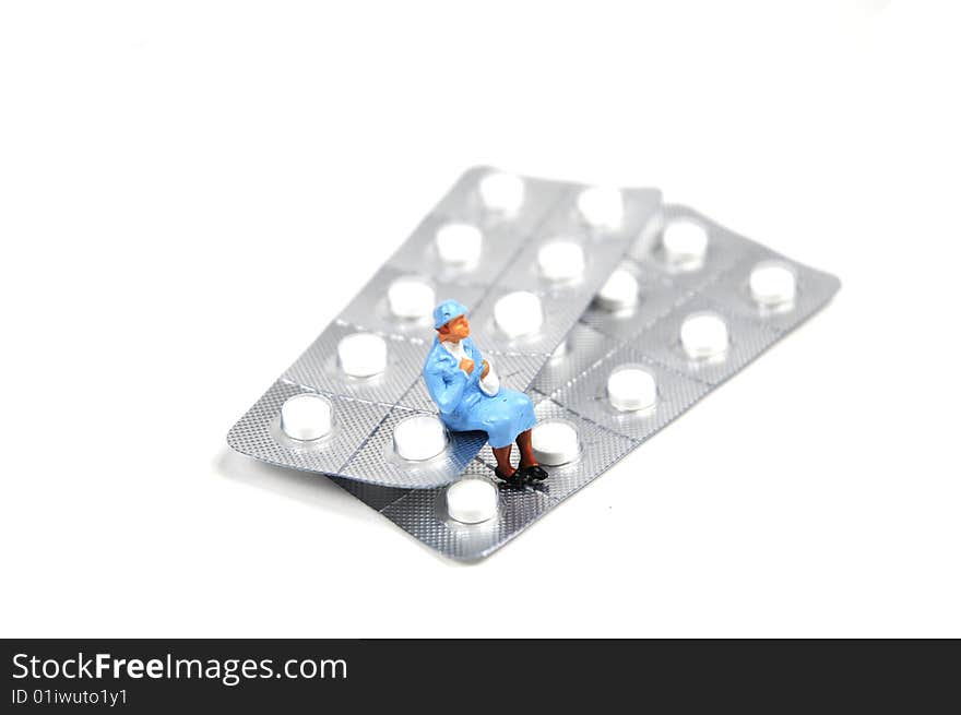 An old lady sitting on a strip of tablets. An old lady sitting on a strip of tablets