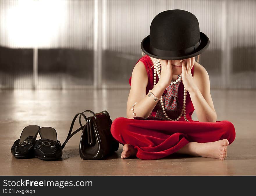 Girl with her face in her hat