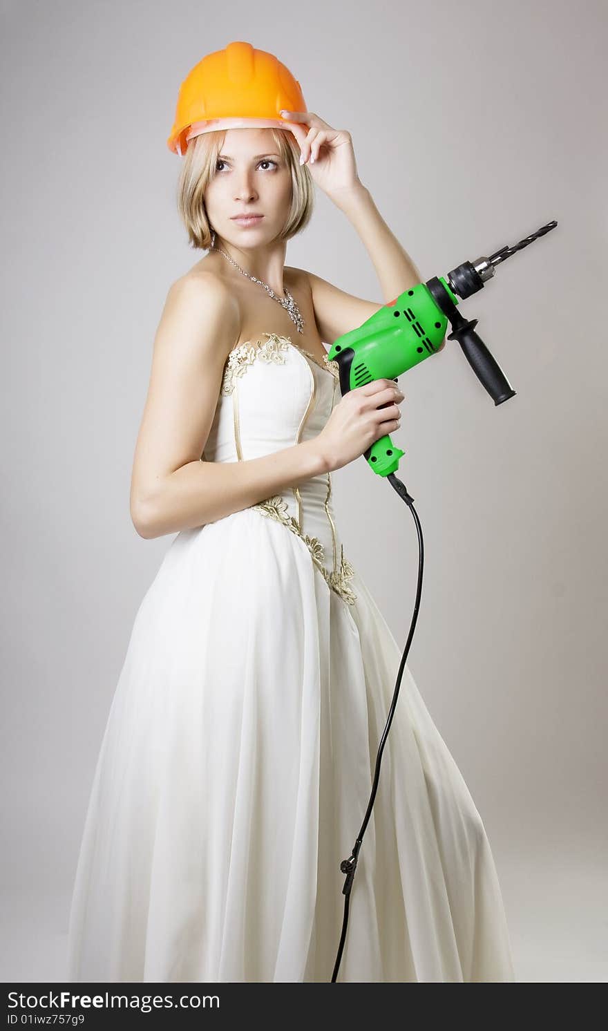 Girl In Evening Dress With A Drill