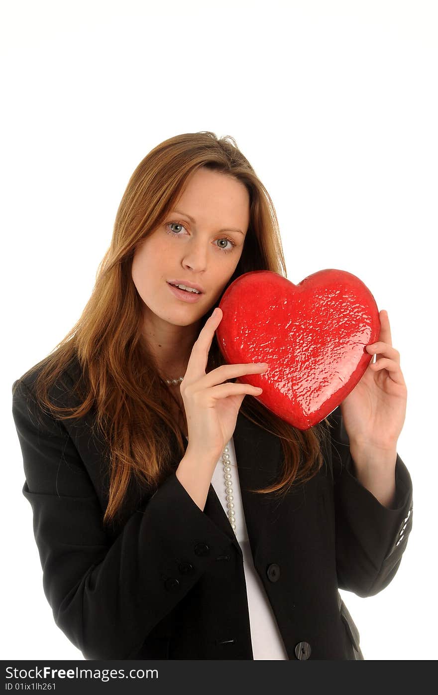 Young woman wearing business outfit. Carrying an artificial heart. Young woman wearing business outfit. Carrying an artificial heart.