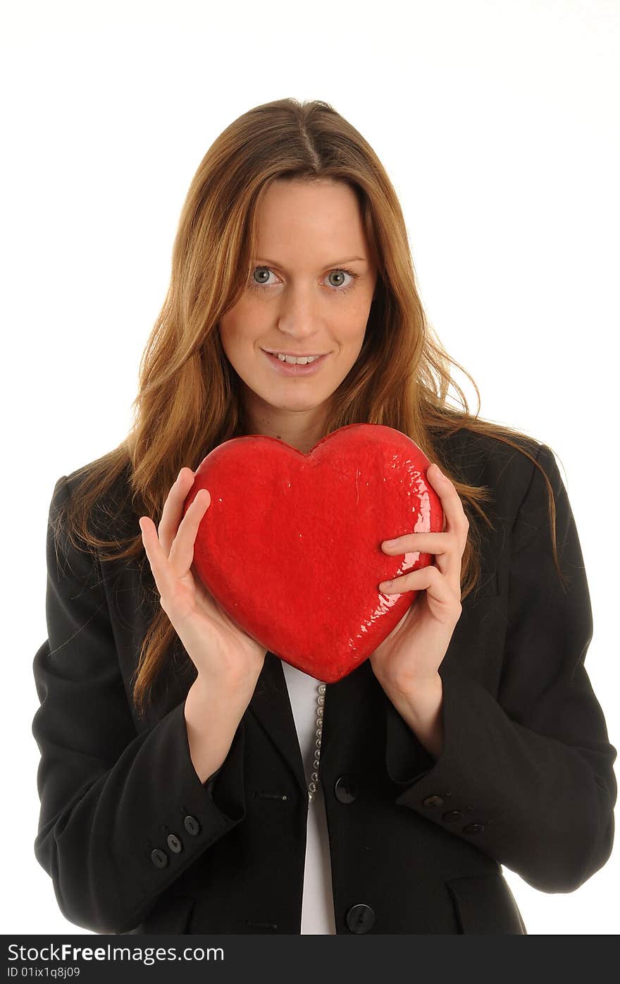 Young woman wearing business outfit. Carrying an artificial heart. Young woman wearing business outfit. Carrying an artificial heart.