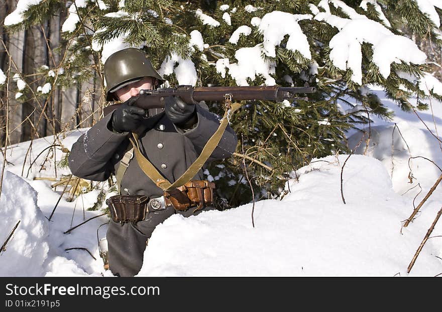 Finnish soldier aims from a rifle