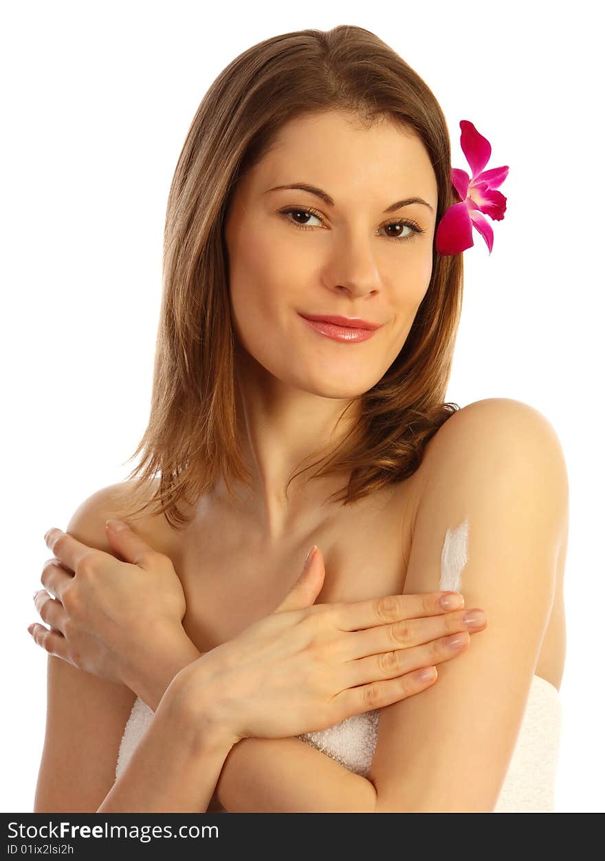 Girl applying cream on her arm. Isolated on white