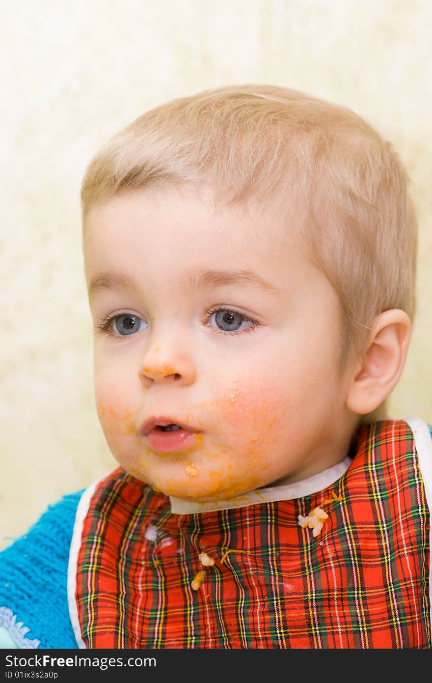 Cute little boy stained with squash