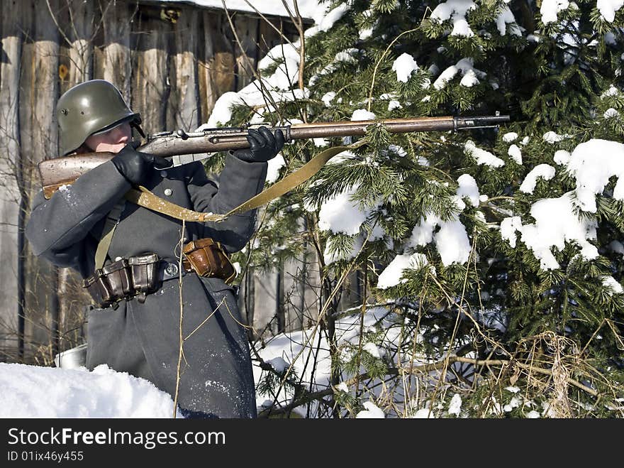 Finnish soldier aims from a rifle