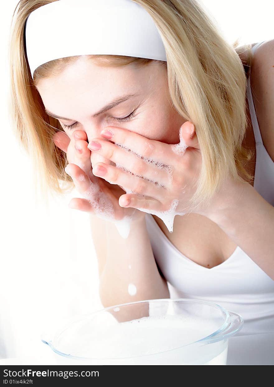 Beautiful woman washing her face