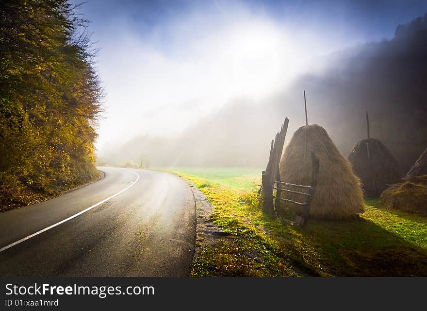 Sunrise on a country road. Foggy autumn morning. Sunrise on a country road. Foggy autumn morning