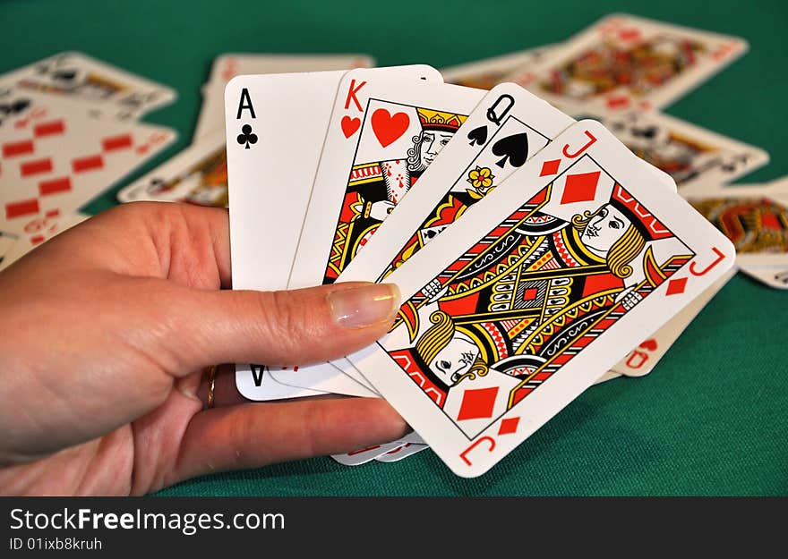 Playing cards in women's hand, blur cards in background. Playing cards in women's hand, blur cards in background