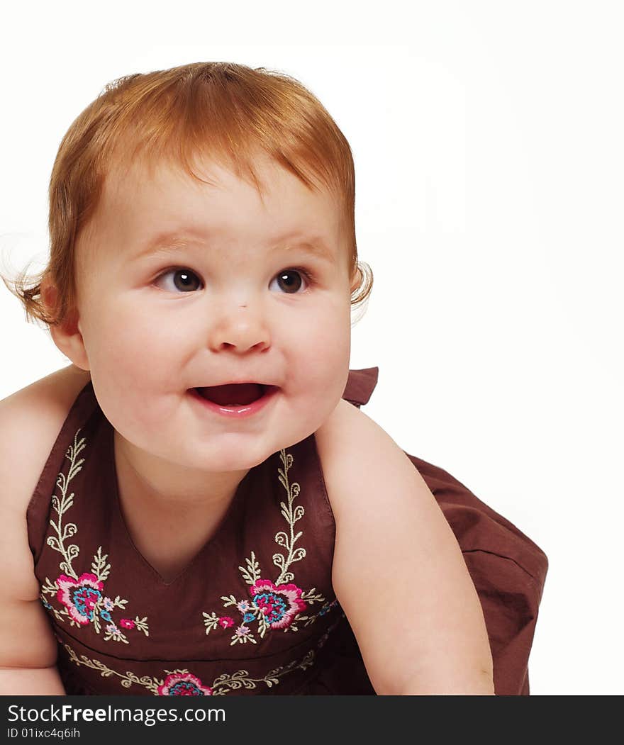 Adorable little baby wearing brown dress holding toy isolated against white background