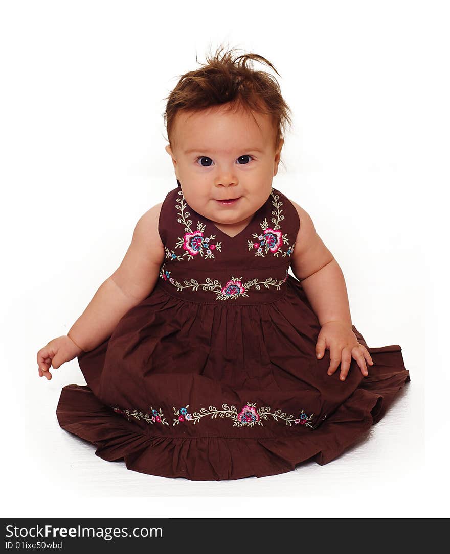 Adorable little baby wearing brown dress isolated against white background