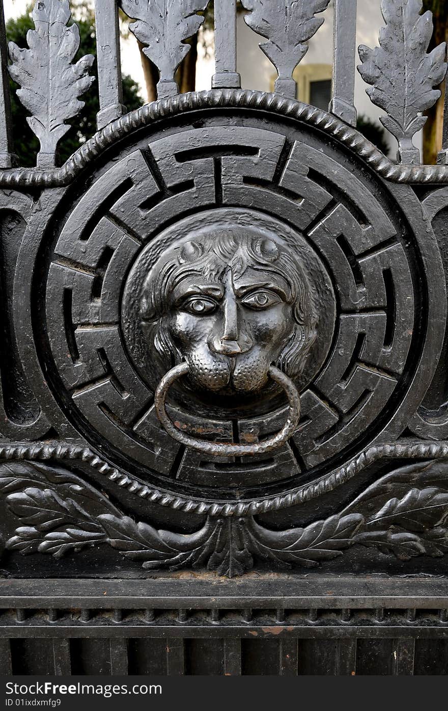 Black iron doorknocker in shape of a lion