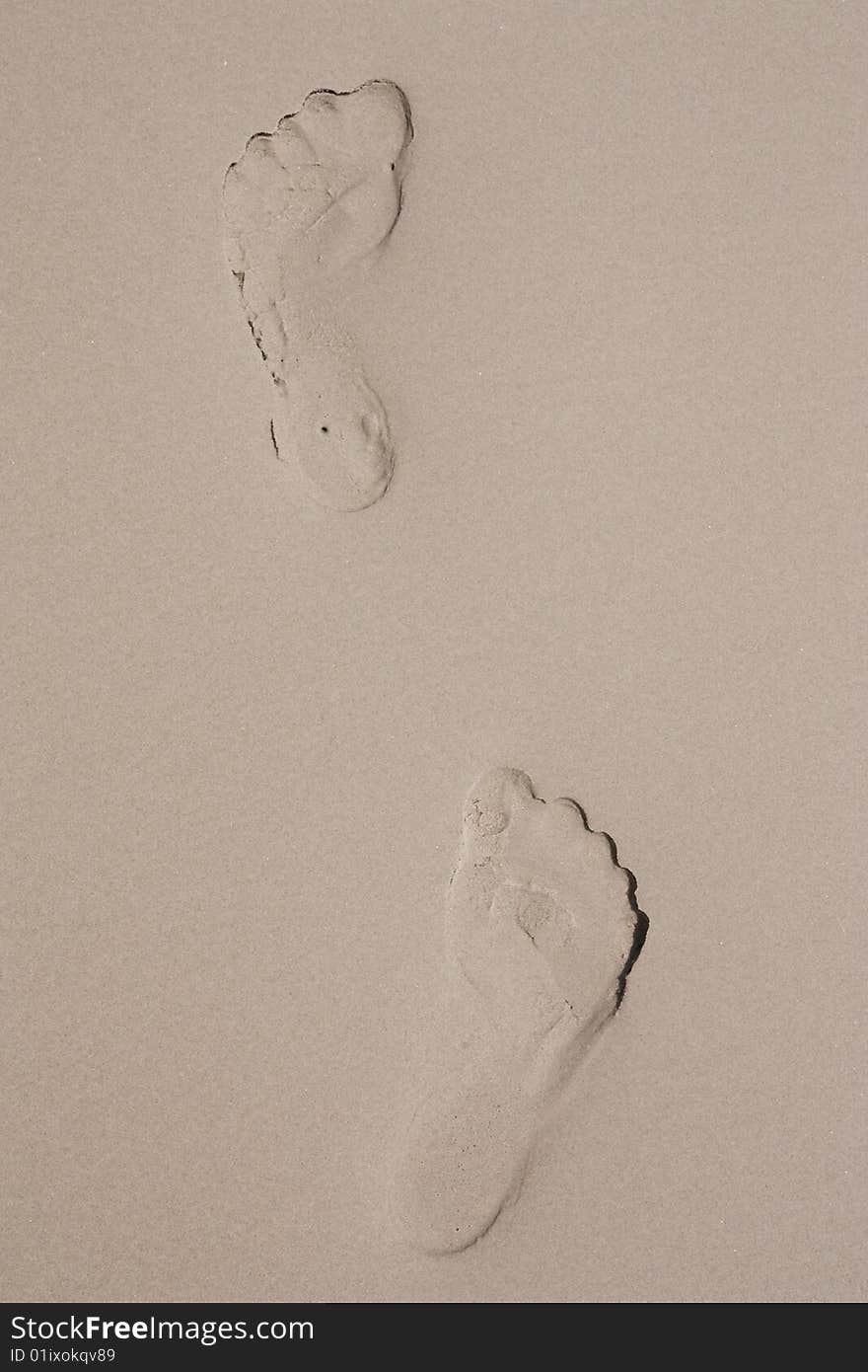 Foot Prints On Sand Beach.