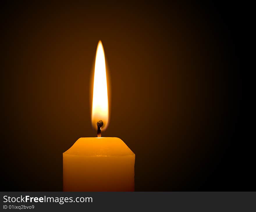 Macro of burning candle on black background