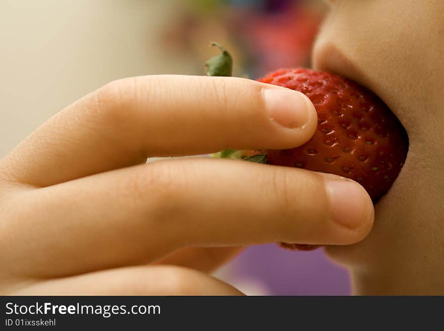 Strawberry inside the child\'s mouth. Strawberry inside the child\'s mouth.