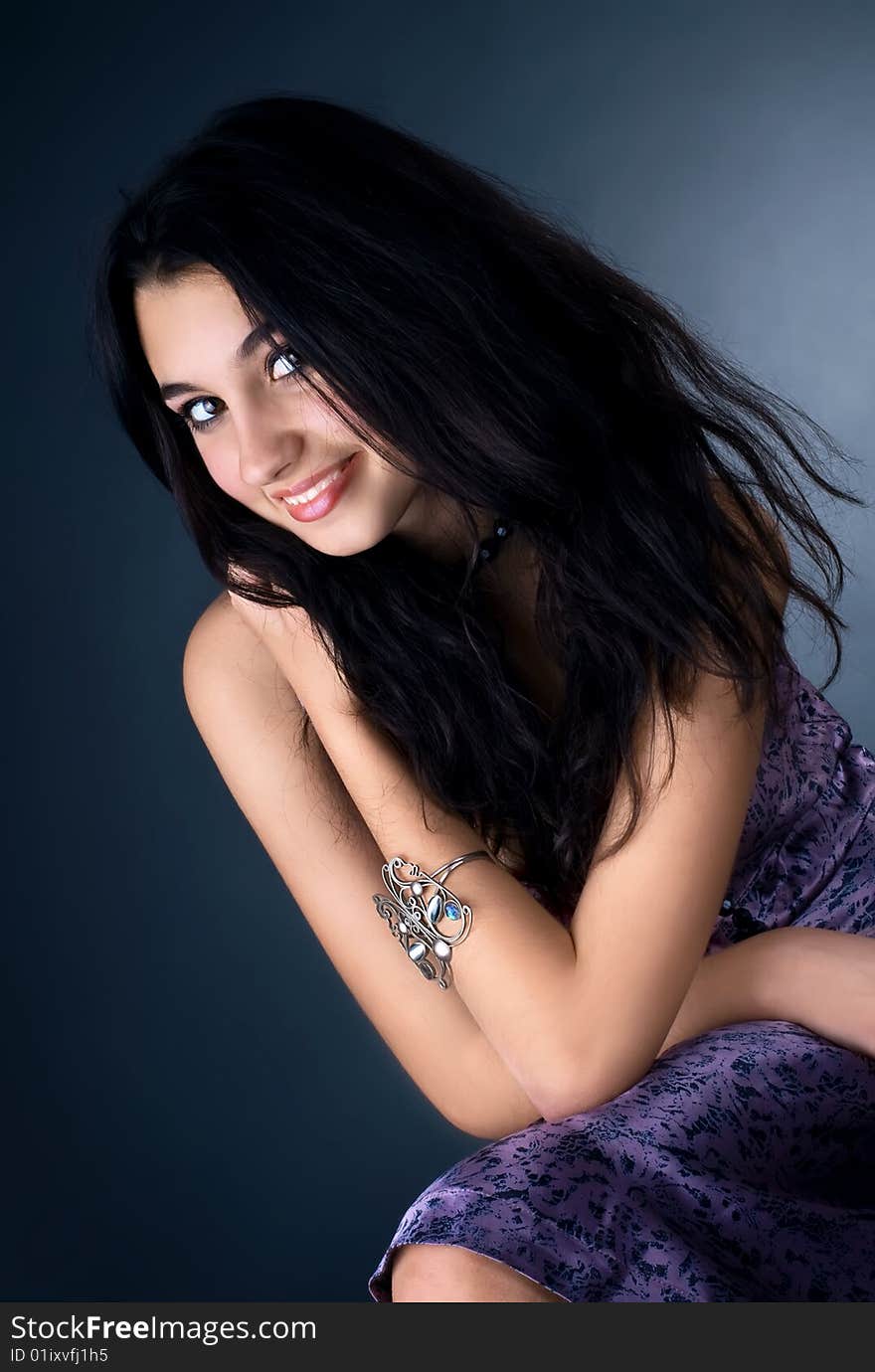 Series. Portrait of the beautiful brunette in a dark blue dress