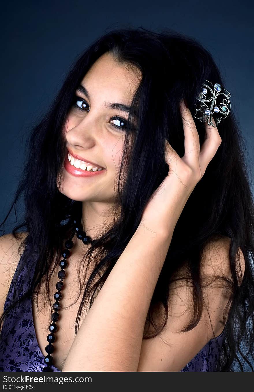 Series. Portrait of the beautiful brunette in a dark blue dress