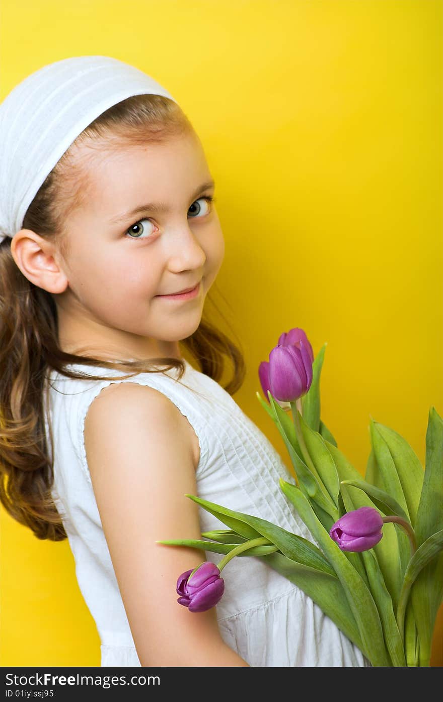 Smiling beautiful young girl with tulips at spring. Smiling beautiful young girl with tulips at spring