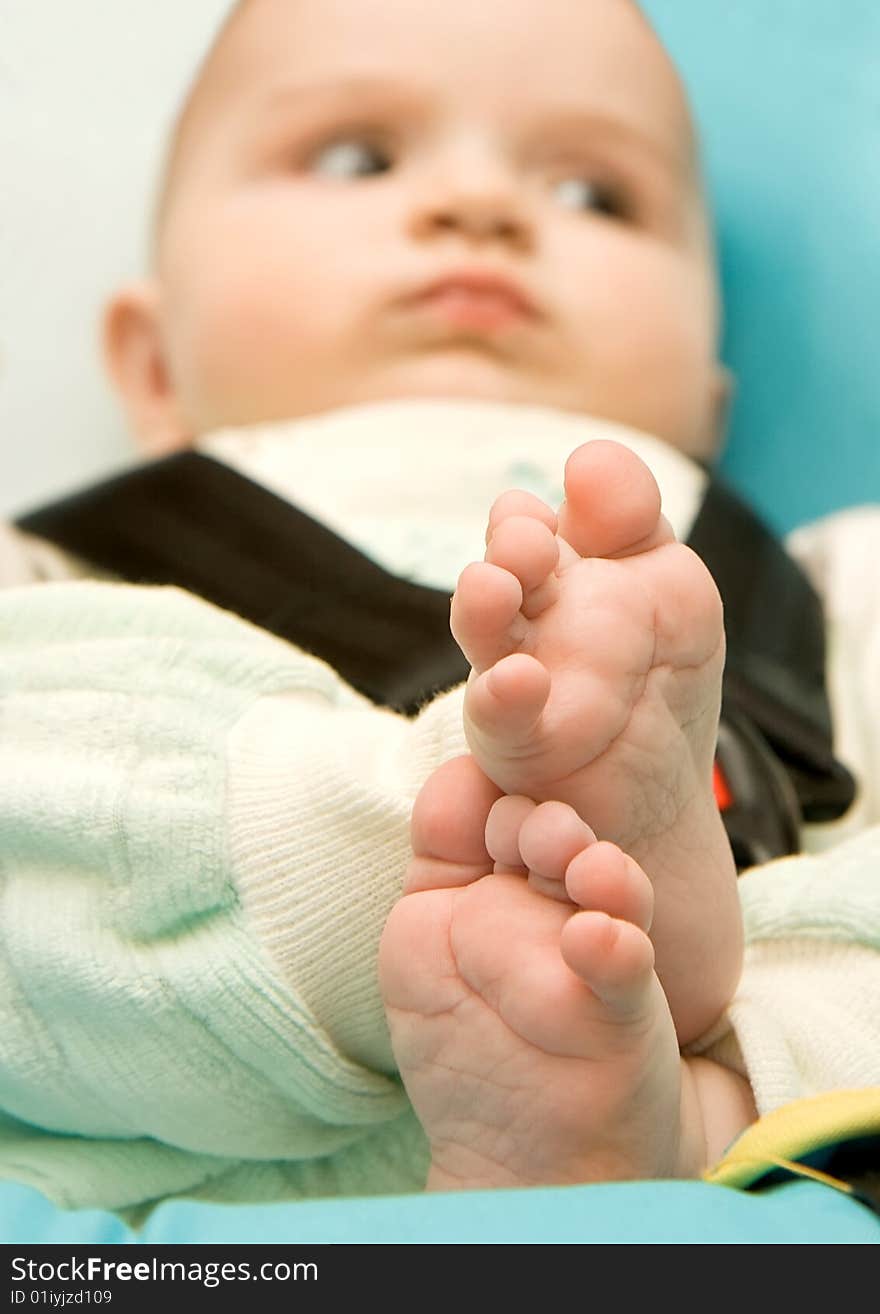 Relaxing baby, in focus his foot