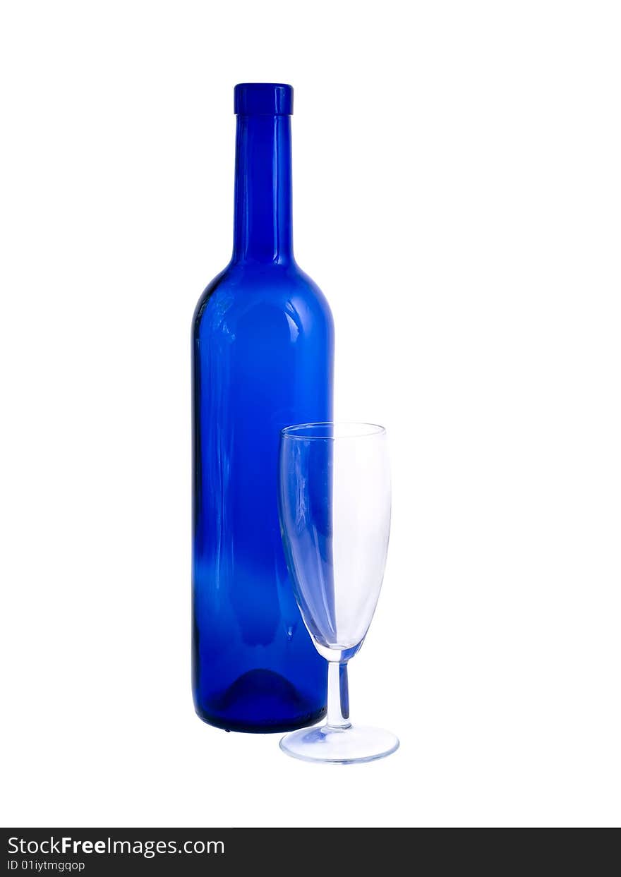 An empty blue bottle and wineglass isolated on white