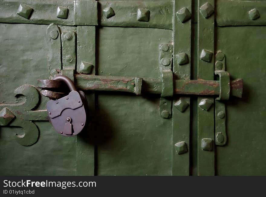 Old green iron door with lock. Old green iron door with lock