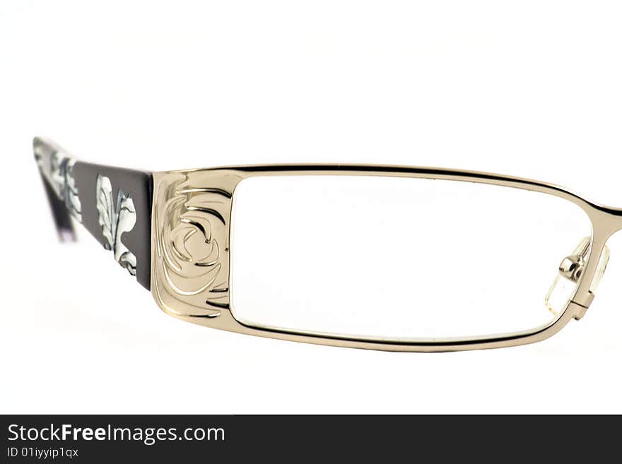 Close up at woman's glasses' lens on a white background. Close up at woman's glasses' lens on a white background