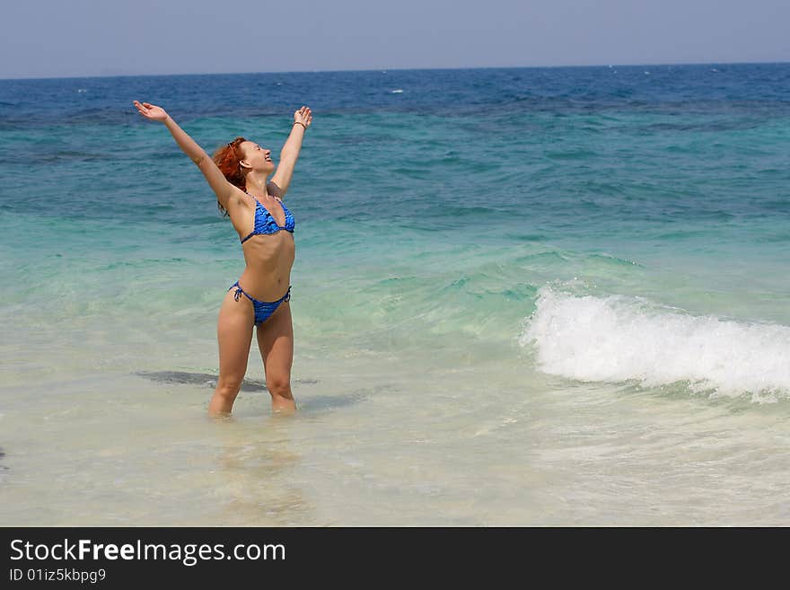 The girl in the sea with the hands lifted upwards