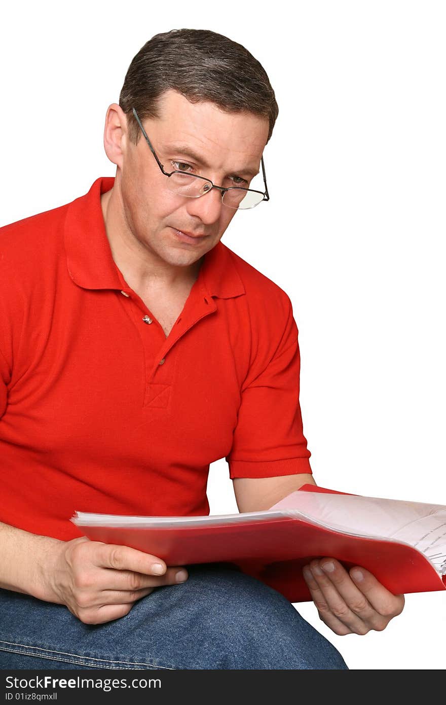 The man in glasses studies documents in a red folder. The man in glasses studies documents in a red folder