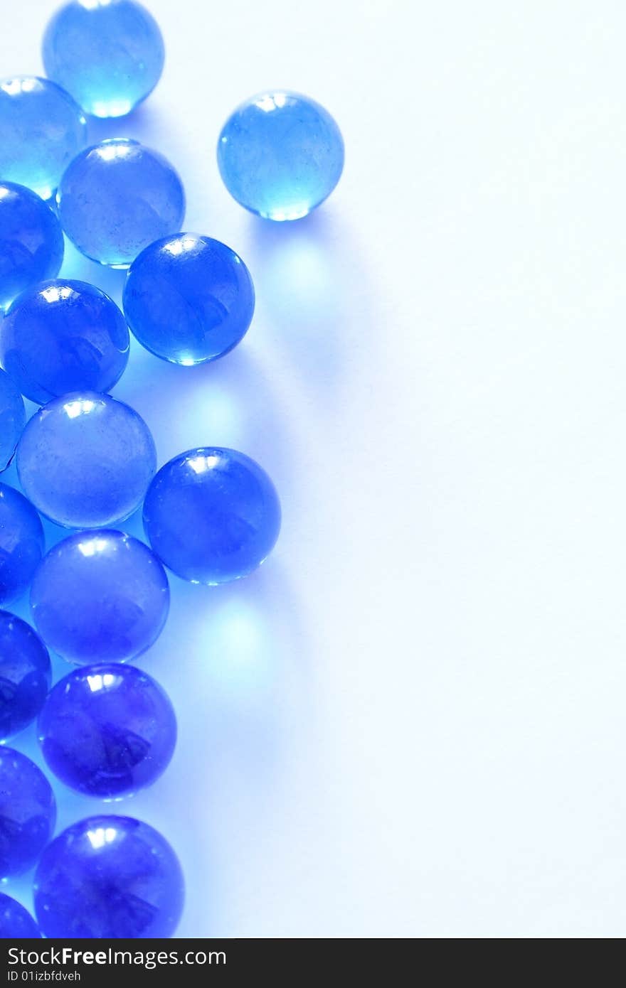 Blue glass beads on a white background