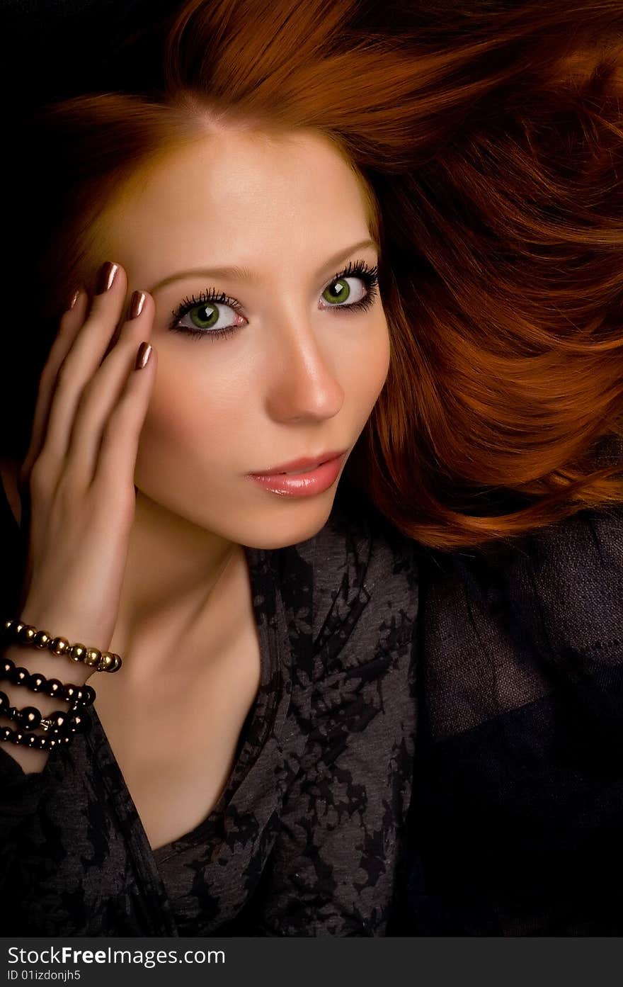 Studio portrait of a beautiful young girl with red hair