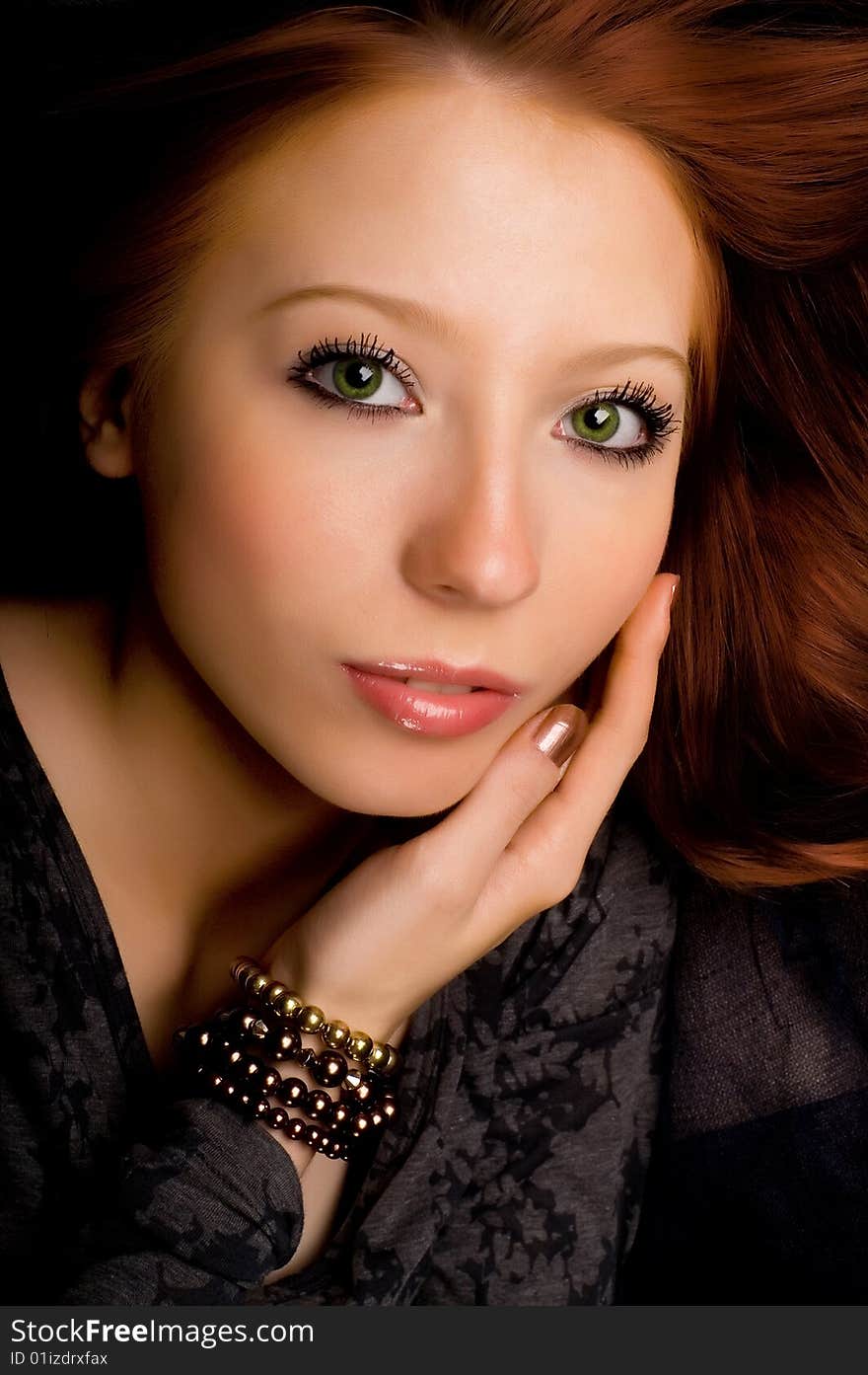 Studio portrait of a beautiful young girl with red hair