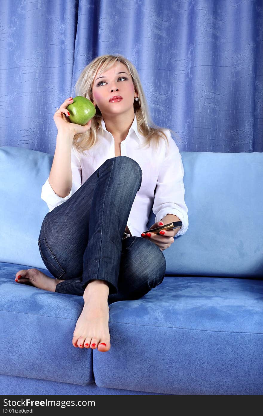 Girl with apple and phone in room