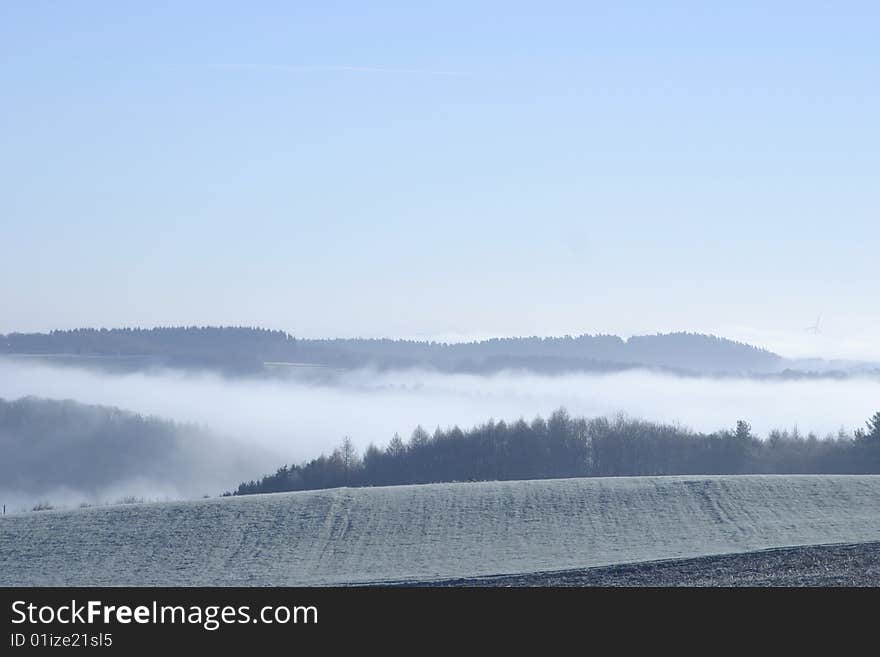 Fog over frozen ridges and slopes. Fog over frozen ridges and slopes