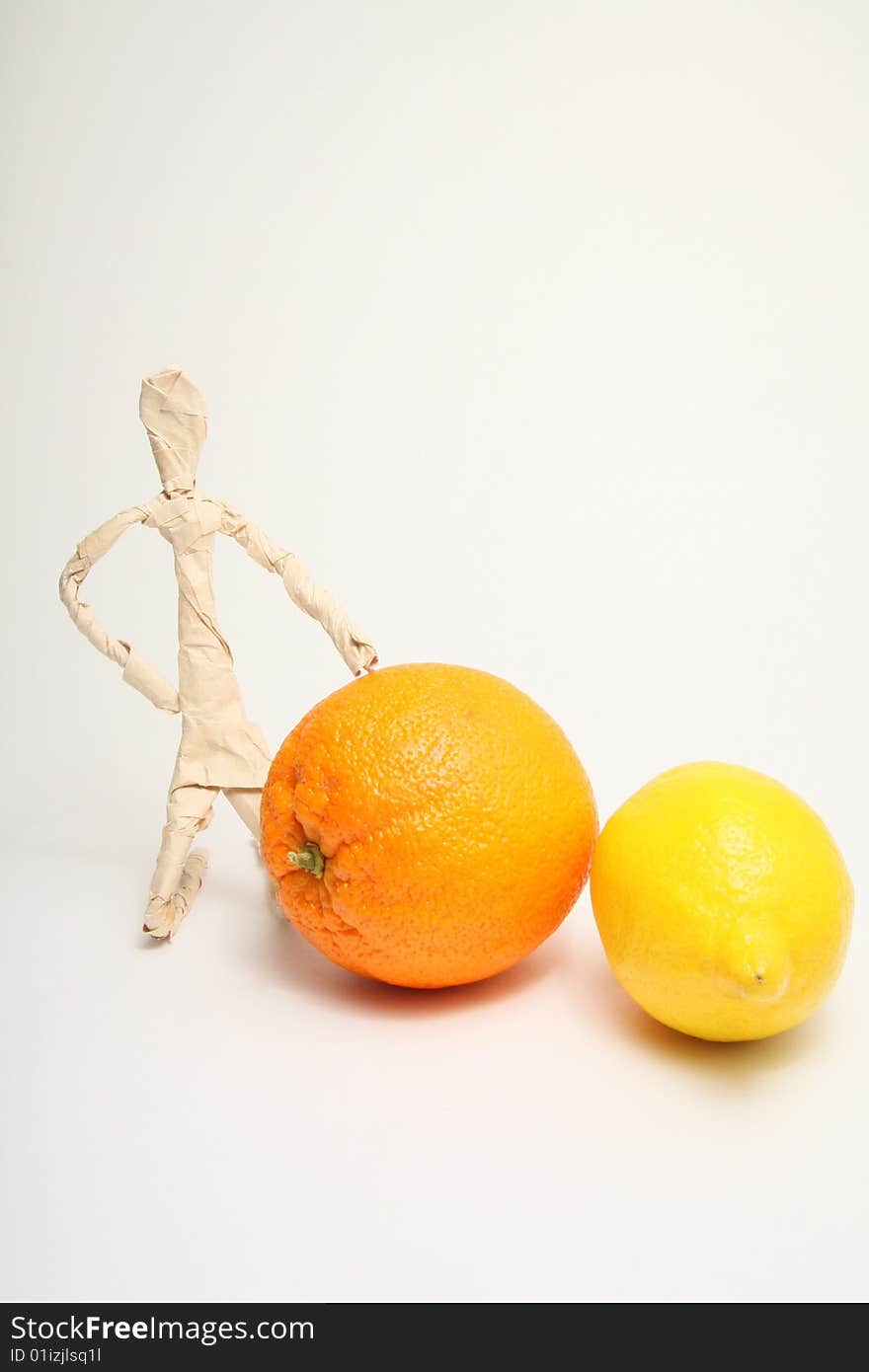 Figure of paper man with lemon and orange. Figure of paper man with lemon and orange