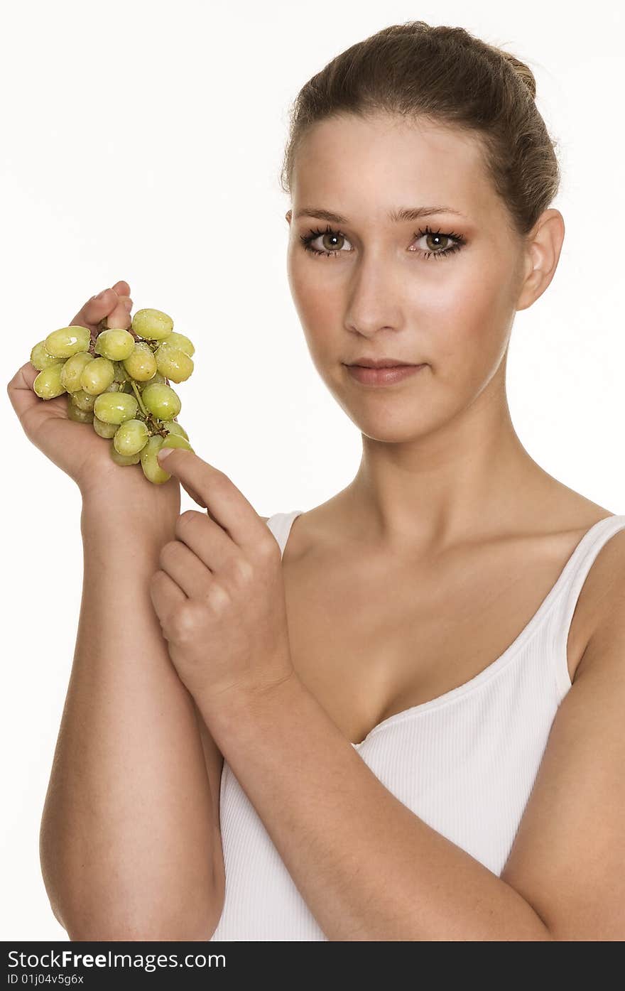 Pretty young woman enjoying fresh grapes