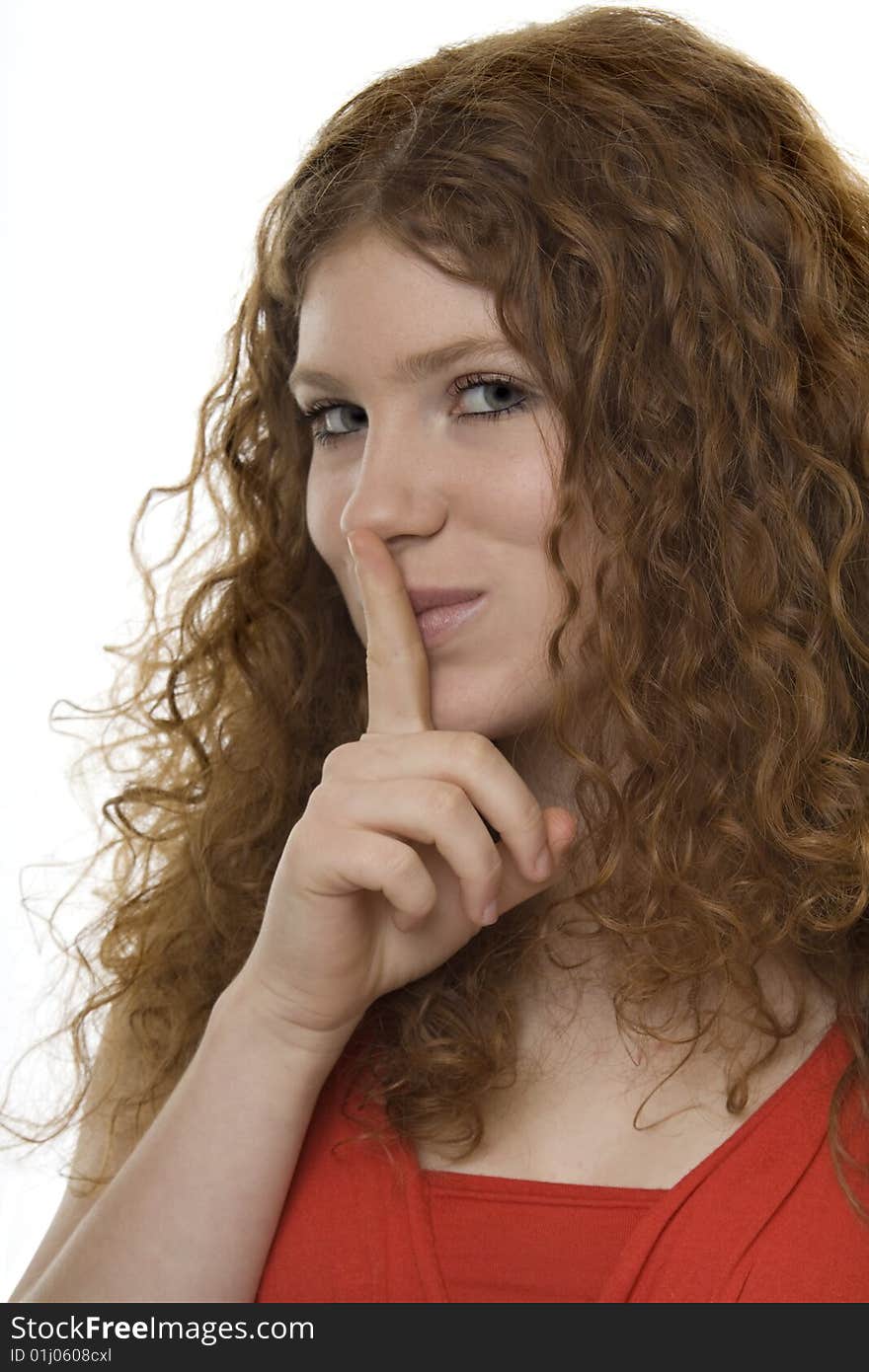 Woman with gestures quiet, a finger in front of the mouth