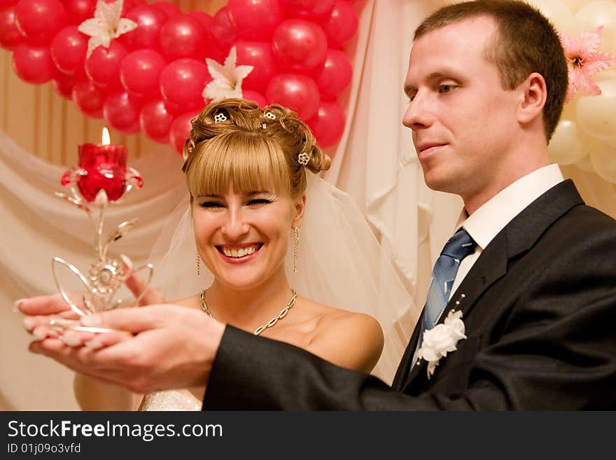 Young bride and bridegroom with candle. Young bride and bridegroom with candle