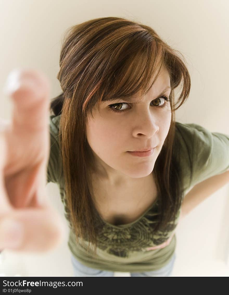 A nosy woman tapping or pointing toward camera.