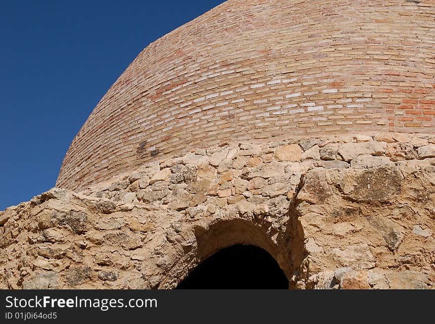 The domed roof of a Spanish snow well, or pozo de nieve. This beautiful building stands high in the mountains and 
was used in past times to make ice for icecream and cold drinks! The dome is made of bricks, which are good insulation. The cool wind blows through the open arched doorway. The sky above is a stunning blue. The domed roof of a Spanish snow well, or pozo de nieve. This beautiful building stands high in the mountains and 
was used in past times to make ice for icecream and cold drinks! The dome is made of bricks, which are good insulation. The cool wind blows through the open arched doorway. The sky above is a stunning blue.