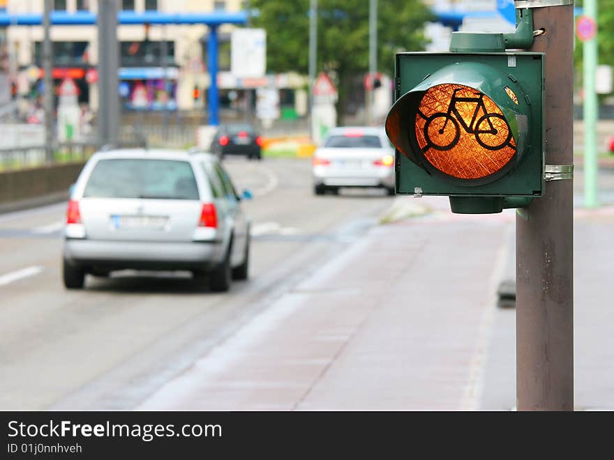 Bicycle roadsign on the street with cars