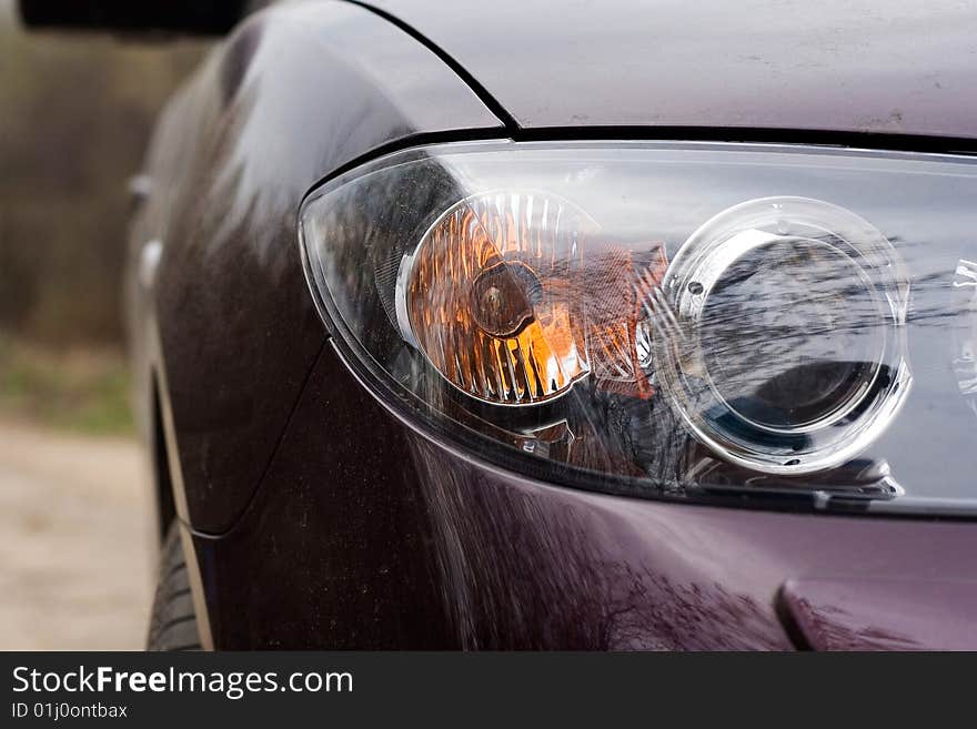 Forward headlight of the car of violet colour