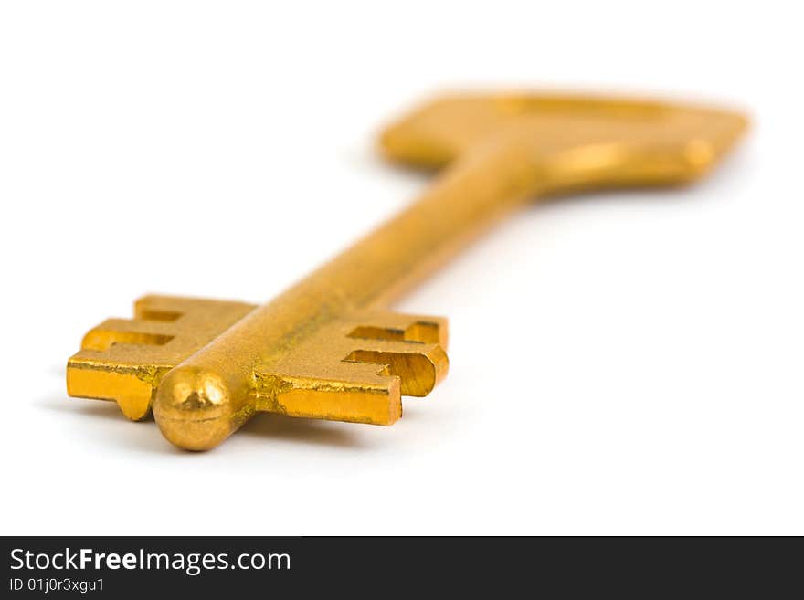 Macro of retro gold key isolated on white background