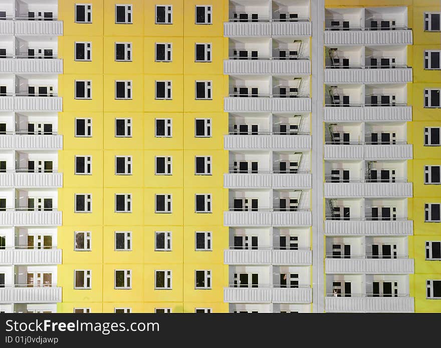 Yellow building with white balconies